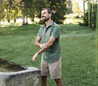 Mann steht vor einer Tröge mit Kneipp-Wasser