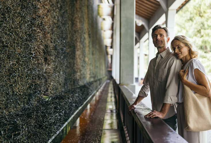 Ein Paar steht vor einer Mooswand und genießt das gute Klima